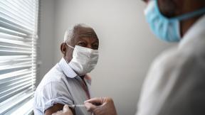 A man receiving the COVID-19 vaccination.