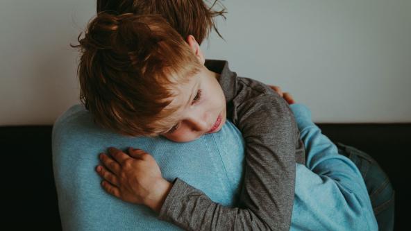 A child embraces their mother.