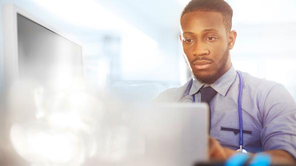 A doctor using a laptop.
