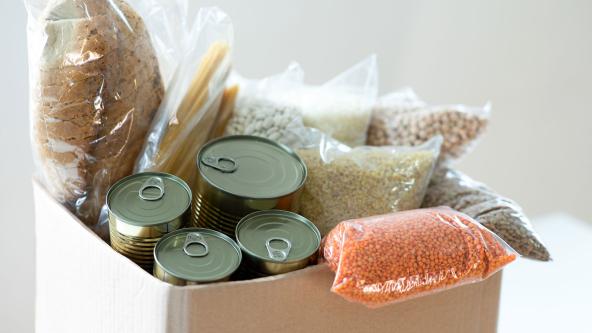 A filled food bank donation box.