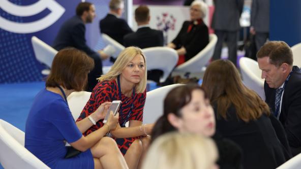 Seated group of delegates talking intently