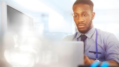 A doctor using a laptop.