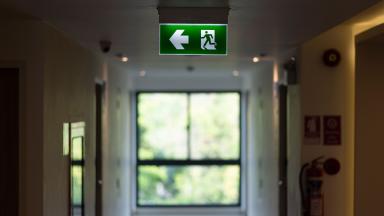 An exit sign in a hospital corridor.