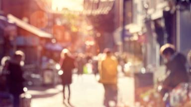 Crowd shopping on a high street, slightly blurred