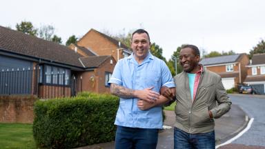 Community nurse walking with a service user