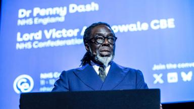 Lord Adebowale delivering a speech behind a lecturn