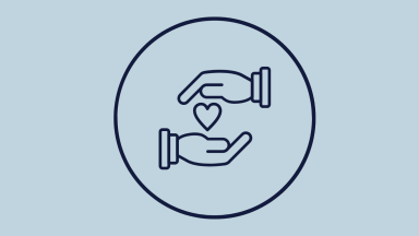 Two hands holding a heart to depict charity