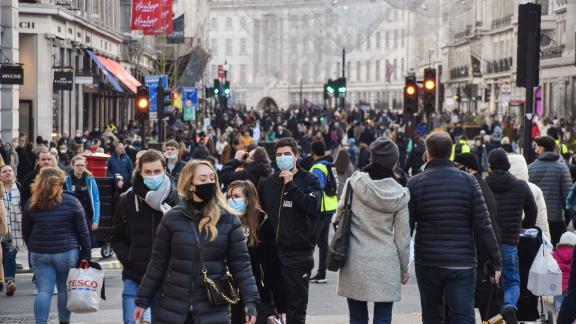 A busy London street with masked people.