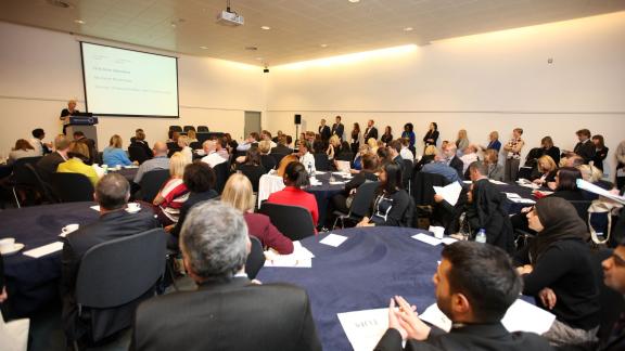 Packed room of conference delegates mainly seated