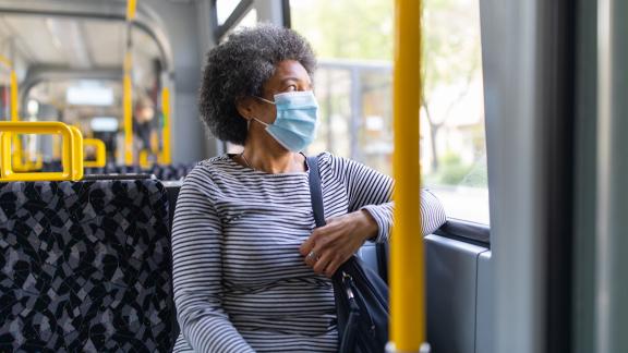 A masked bus passenger.