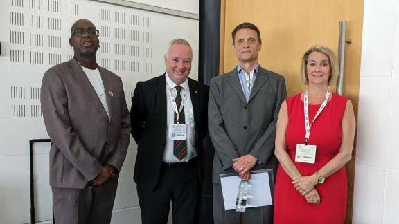 Group standing and smiling. From left to right: Patrick Vernon, Kevin Lavery, Matthew Taylor and Amanda Sullivan.