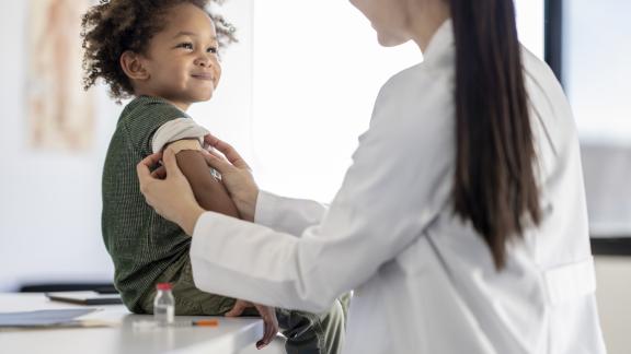 Doctor or nurse giving a child a vaccination