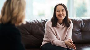 A woman in counselling, smiling.