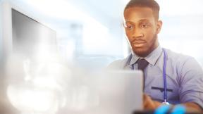 A doctor using a laptop.