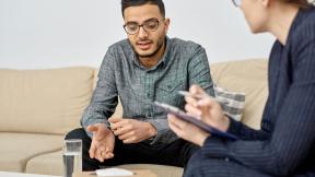 A man in counselling, talking.