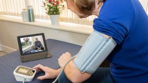 Video consultation as patient takes blood pressure