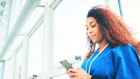 Health care worker reading on a phone