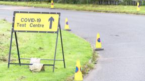 A road sign reading "COVID-19 test centre".