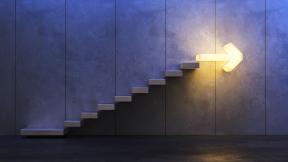 Stairs going upwards with bright arrow at the top