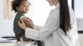 Doctor-or-nurse-giving-child-vaccination
