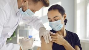 Doctor-or-nurse-giving-young-person-vaccination
