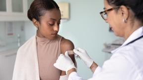 Doctor-or-nurse-giving-young-person-vaccination