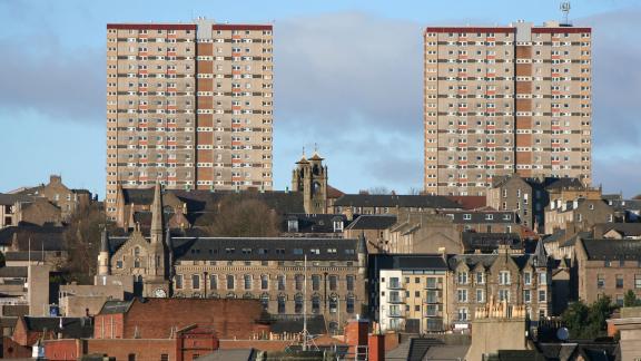 A block of flats above a town.