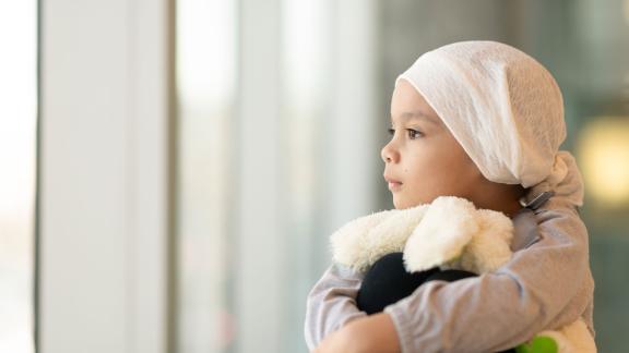 A child hugs a soft toy.