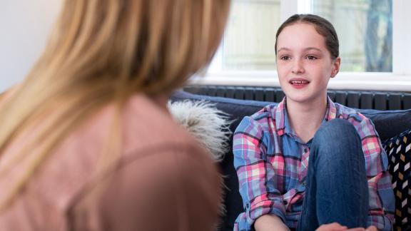 A girl talks to a counsellor.