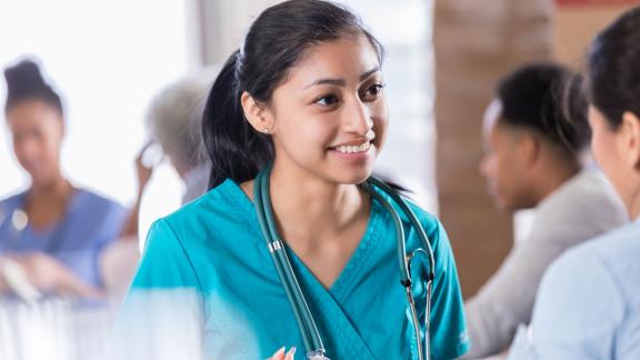 A smiling doctor having a conversation.