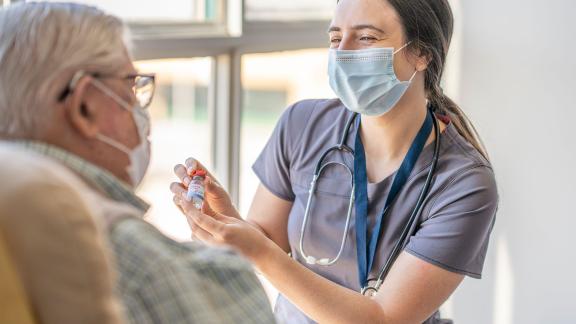 A doctor giving a patient a COVID-19 vaccination.