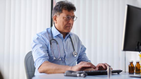 A general practitioner, typing.