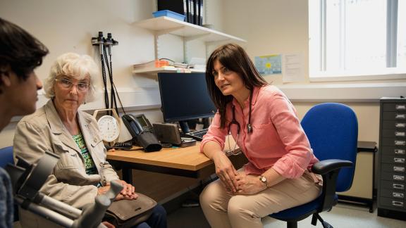 A general practitioner talking with patients.