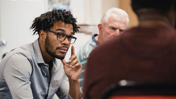 A man listens during a group counselling session.