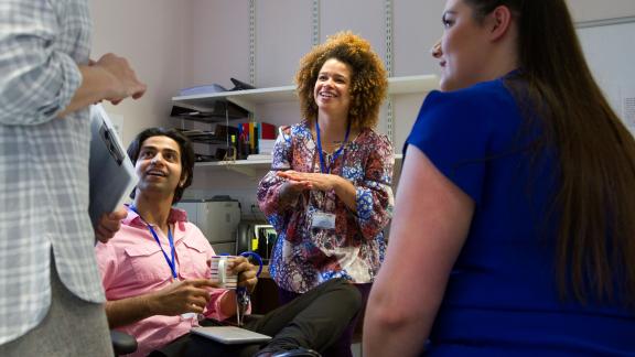 Group of staff talking in office