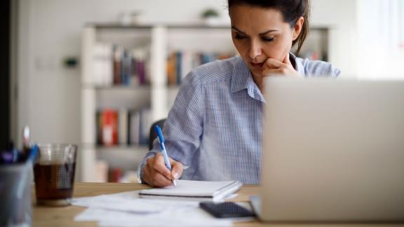 A homeworker making notes.