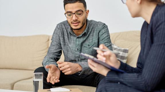 A man in counselling, talking.