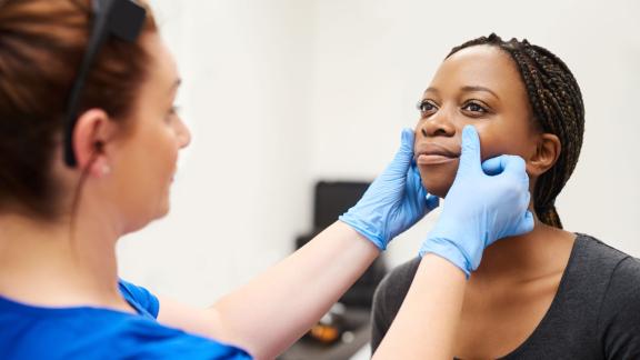 NHS worker examining young patient