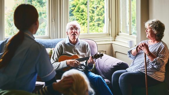 Older patients playing guitar as art therapy