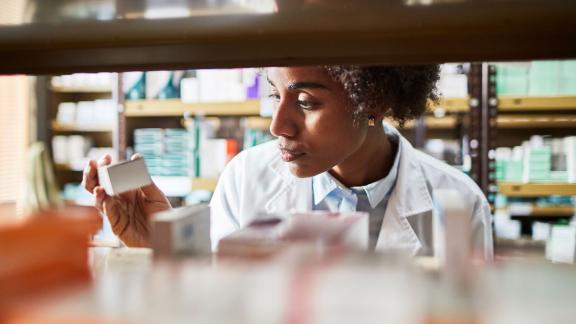 Pharmacist checks a medicine box.