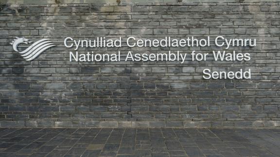 A sign on the wall of the Senedd building.