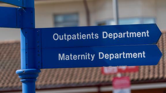 Sign showing outpatient and maternity departments