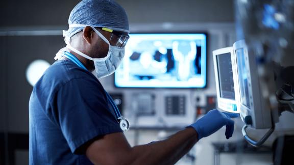 A surgeon checking a monitor.