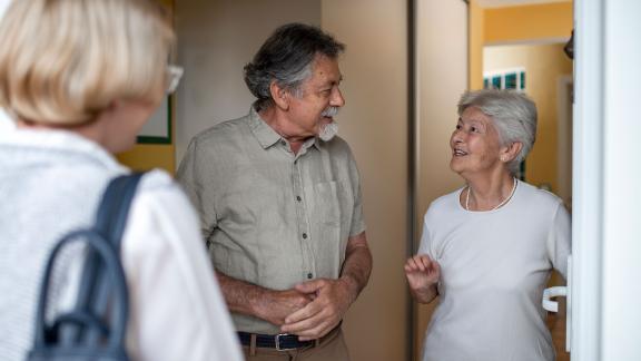 A friend visiting an older couple.