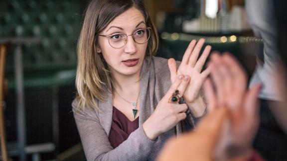 A woman talking in sign language. 