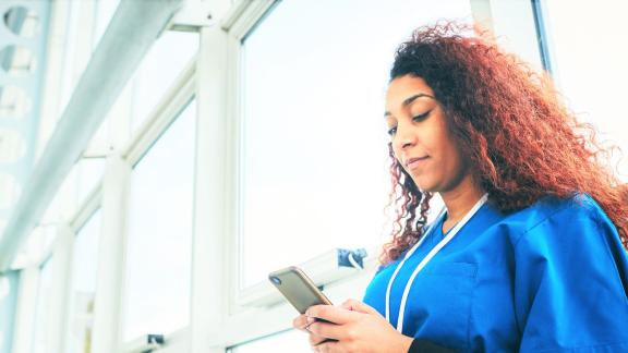 Health care worker reading on a phone