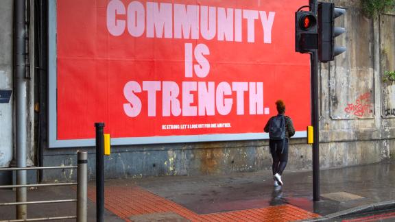 Billboard displaying the message 'community is strength'