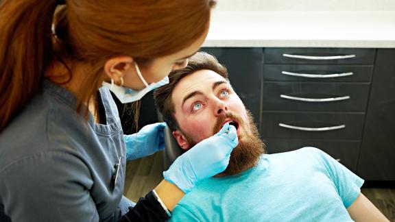 A dentist and patient mid-appointment.