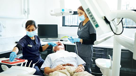 A dentist and dental assistant during an appointment.