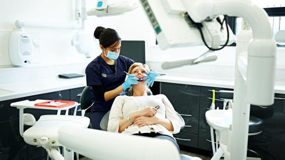 A dentist and patient mid-appointment.